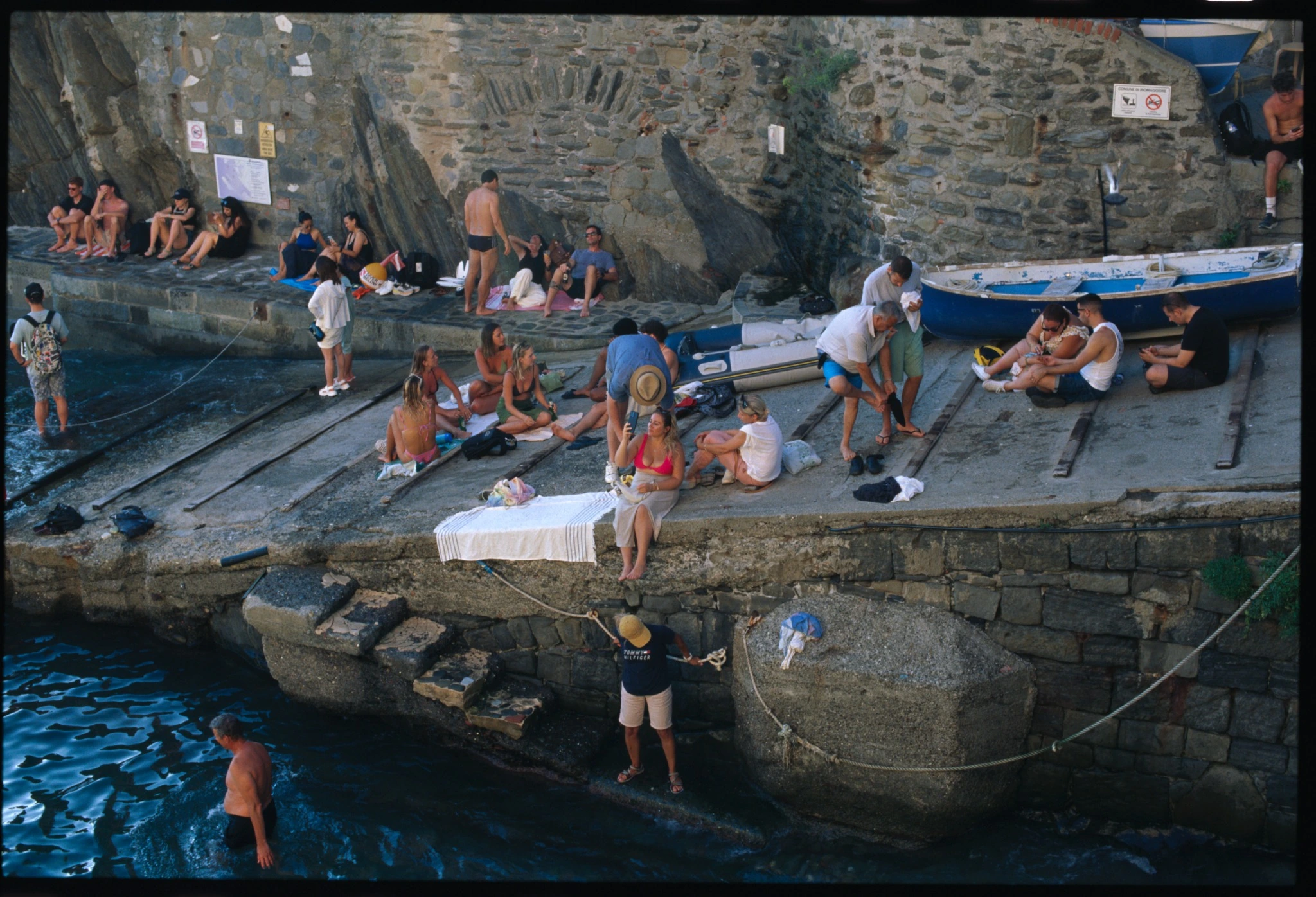 Kodak E100 film scan of a small Cinque Terre harbour and swimmers