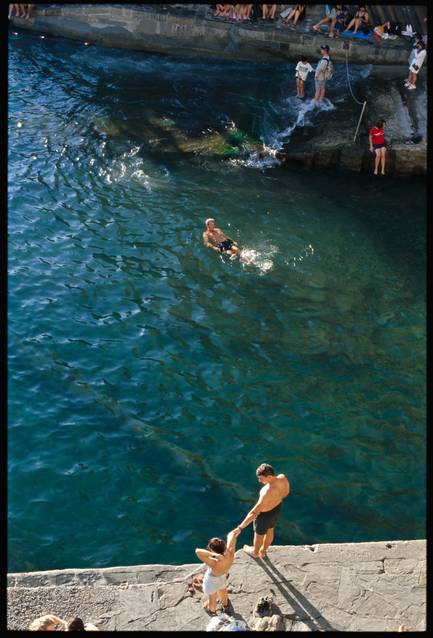 Kodak E100 35mm slide film scan with swimmers in clear Mediterranean water