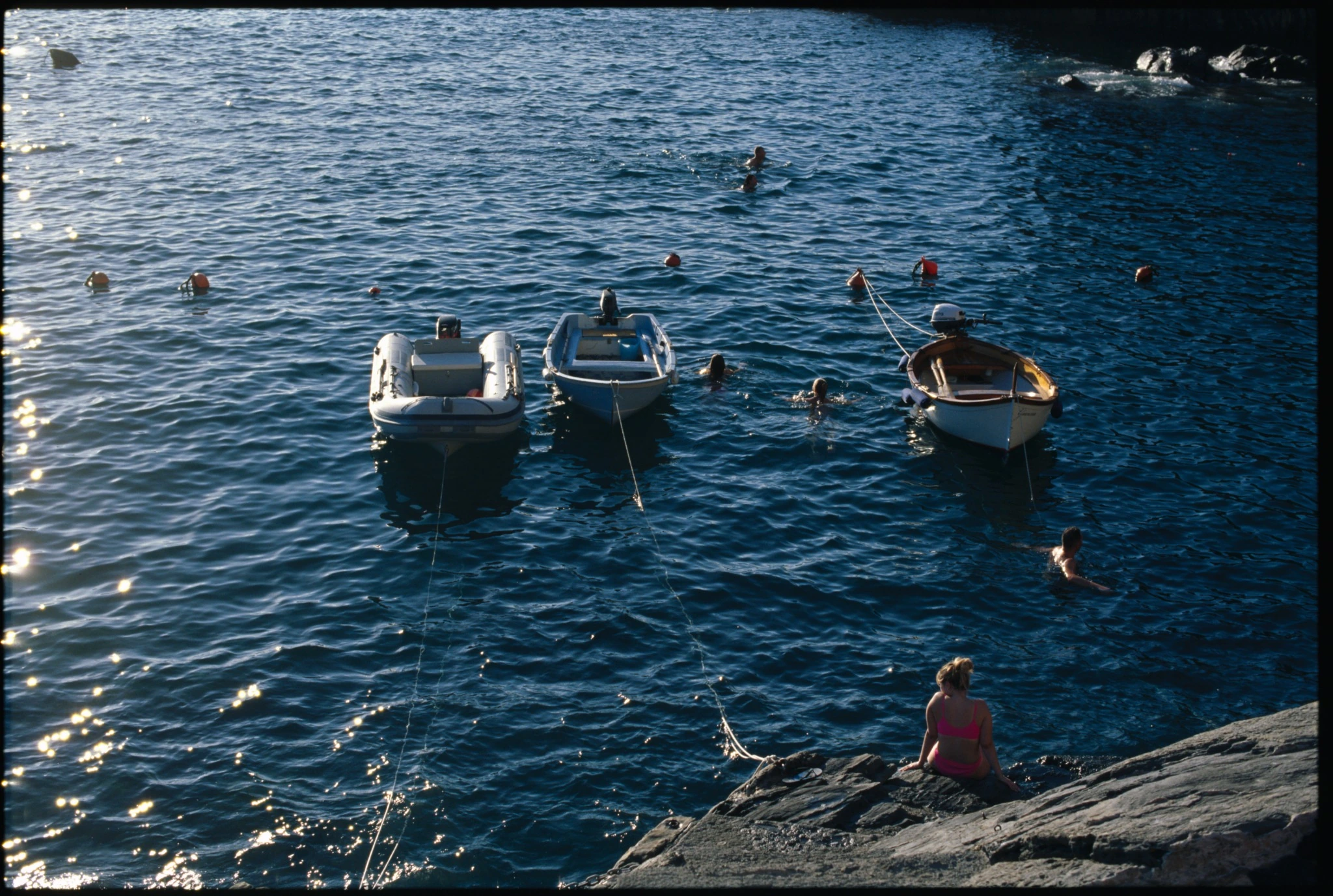 Kodak E100 wet-mounted scan showing boats, swimmers and reflected sunlight on the sea